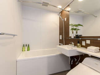 Experience modern comfort in this well-appointed bathroom featuring a deep soaking tub perfect for relaxation.