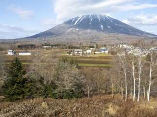 Discover your dream home nestled in a serene landscape with a majestic snow-capped mountain as your backdrop.