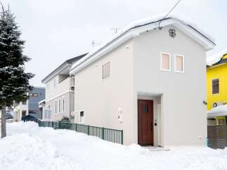 Discover this charming two-story home nestled in a serene, snow-covered neighborhood.