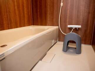 Experience ultimate relaxation in this modern bathroom featuring a deep soaking tub perfect for unwinding.