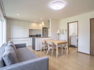 Discover modern living in this open-concept apartment, featuring a sleek kitchen with ample cabinet space and integrated appliances.