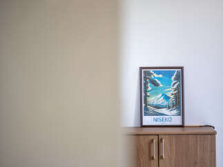 Enhance your living space with this charming framed artwork depicting a serene winter landscape of Niseko, Japan.