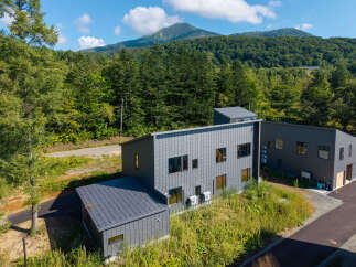 Discover modern living nestled amidst lush greenery and scenic mountain views.
