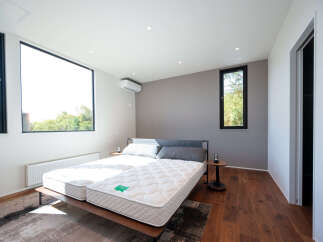 Experience modern comfort in this spacious bedroom featuring two twin mattresses on a sleek platform bed.