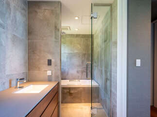 Experience modern luxury in this stunning bathroom, featuring a sleek vanity with a vessel sink and a chrome faucet.