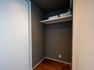 Discover ample storage in this modern closet, featuring a convenient shelf and hanging rod.