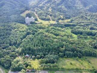 Discover this expansive property nestled amidst lush greenery and rolling hills, offering a serene escape.