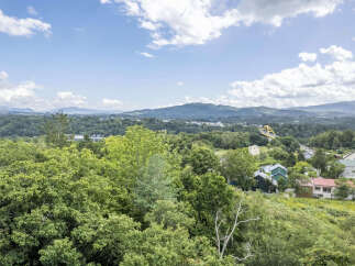 Nestled amidst lush greenery and rolling hills, this property offers a serene escape with breathtaking panoramic views.