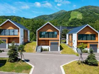 Discover modern mountain living in these stunning contemporary homes, featuring sleek wood and white exteriors and expansive windows that capture breathtaking natural light.