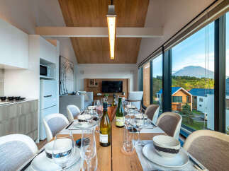 Experience luxurious dining with a stunning mountain view from this modern home.
