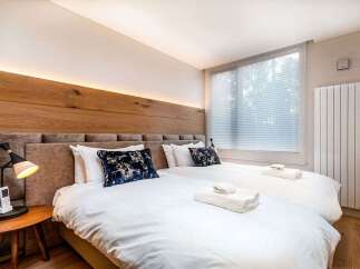 Experience ultimate comfort in this beautifully appointed bedroom featuring two plush twin beds, perfect for accommodating guests or family.