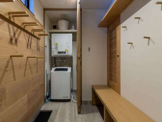 Discover a smart and organized living space featuring a compact laundry area with a stacked washer and dryer, perfect for maximizing utility in a smaller footprint.