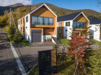Discover modern living in this stunning multi-story home, featuring a striking combination of white and natural wood siding.