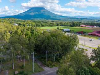 Discover this stunning property nestled amidst lush greenery, offering breathtaking views of a majestic mountain.