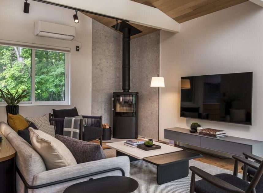 Experience modern living in this beautifully designed living room, featuring a sleek wood-burning stove as a focal point.