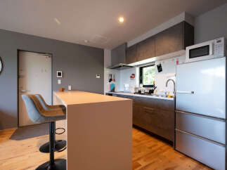 This modern kitchen features a sleek island with bar seating, perfect for casual dining or entertaining.