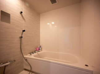 Experience ultimate relaxation in this modern bathroom featuring a deep soaking tub, perfect for unwinding after a long day.