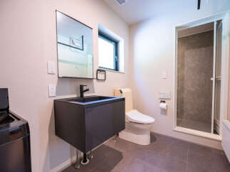 Discover modern comfort in this well-appointed bathroom, featuring a sleek vanity with a vessel sink and a stylish black faucet.