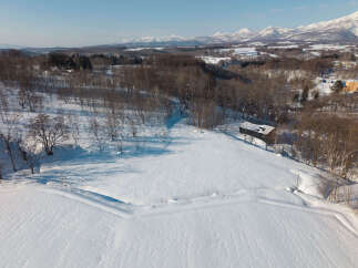 Discover this serene winter landscape, perfect for a peaceful retreat or a unique real estate opportunity.