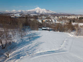 Experience the serene beauty of a winter wonderland with this stunning property nestled amidst snow-covered landscapes.