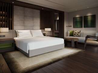 Experience luxury in this masterfully designed bedroom, featuring a plush king-sized bed adorned with crisp white linens and a sophisticated headboard.