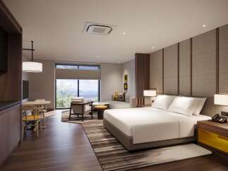 Experience modern comfort in this beautifully appointed hotel suite, featuring a spacious king-sized bed and a cozy seating area.