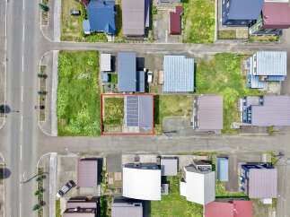 Discover this charming property featuring a modern home with a prominent solar panel installation on its roof, perfect for sustainable living.