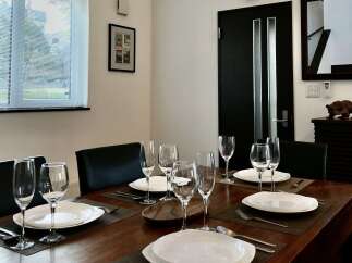 Experience elegant dining in this beautifully set dining room, perfect for hosting guests or enjoying intimate meals.