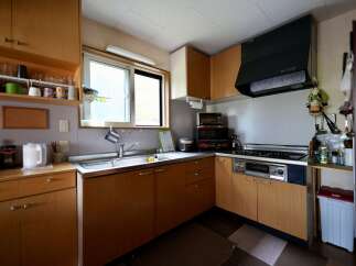 Discover this charming kitchen featuring ample wooden cabinetry for abundant storage.