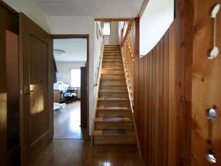 Step into this charming home featuring a beautiful wooden staircase leading to the upper level.