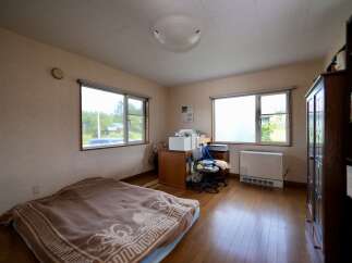 This cozy room features a comfortable bed with a patterned blanket, perfect for relaxation.
