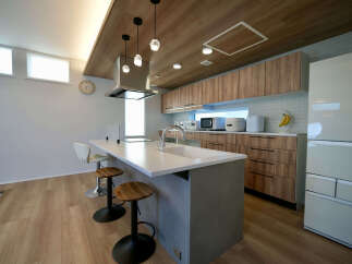 Experience modern living in this stunning kitchen featuring a sleek island with a built-in sink and ample counter space.