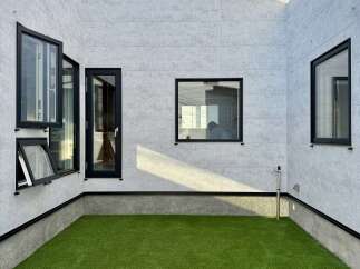 Discover modern living in this stunning property featuring a sleek, minimalist exterior with large windows and a private courtyard.