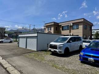 Discover this property featuring a modern two-story building with ample parking space, including a convenient garage with three bays.