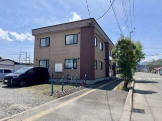 Discover this charming property featuring a modern two-story building with a light brown textured facade and dark brown accents.