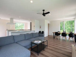 Experience modern living in this spacious open-concept home, featuring a sleek kitchen with a large island and a comfortable living area.