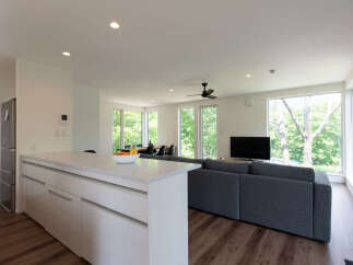 Experience modern living in this open-concept home featuring a sleek kitchen island and a spacious living area.