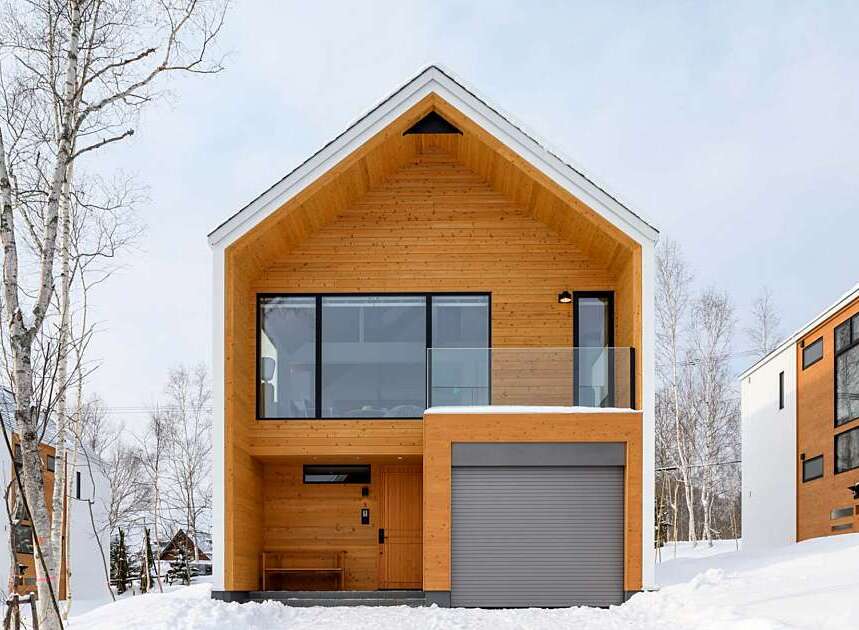 Experience modern living in this stunning wooden-clad home, perfect for a snowy retreat.