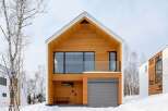 Experience modern living in this stunning wooden-clad home, perfect for a snowy retreat.