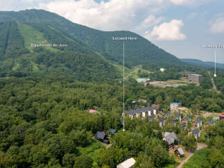 Discover this stunning property nestled amidst the lush greenery of Niseko Village, offering breathtaking views of the Higashiyama Ski Area.
