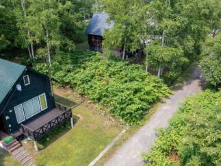 Nestled amidst lush greenery, this charming property features two distinct cabins, perfect for a serene getaway or rental income.
