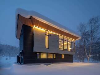Experience modern living in this stunning architectural home nestled in a serene, snow-covered landscape.