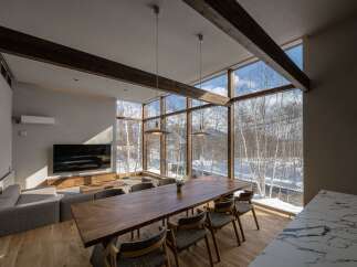 Experience luxurious living with this stunning dining and living area, featuring a massive live-edge wooden dining table perfect for gatherings.