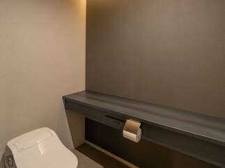 Experience modern comfort in this bathroom featuring a sleek, high-tech toilet with integrated controls.