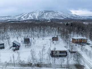 Experience the charm of a winter wonderland with these picturesque chalets nestled amidst snow-covered trees and majestic mountains.