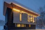 Experience modern luxury in this stunning architectural home, nestled in a serene, snow-covered landscape.