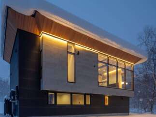 Experience modern luxury in this stunning architectural home, nestled in a serene, snow-covered landscape.