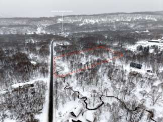 Discover this prime parcel of land nestled in a serene, snow-covered forest, offering a tranquil escape.