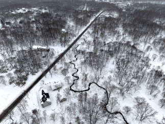Discover a serene winter wonderland with this aerial view of a snow-covered landscape.