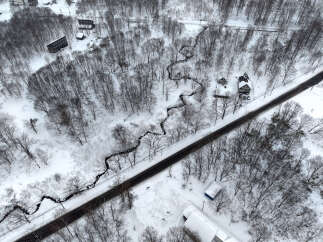 Discover this unique property nestled amidst a serene winter landscape.